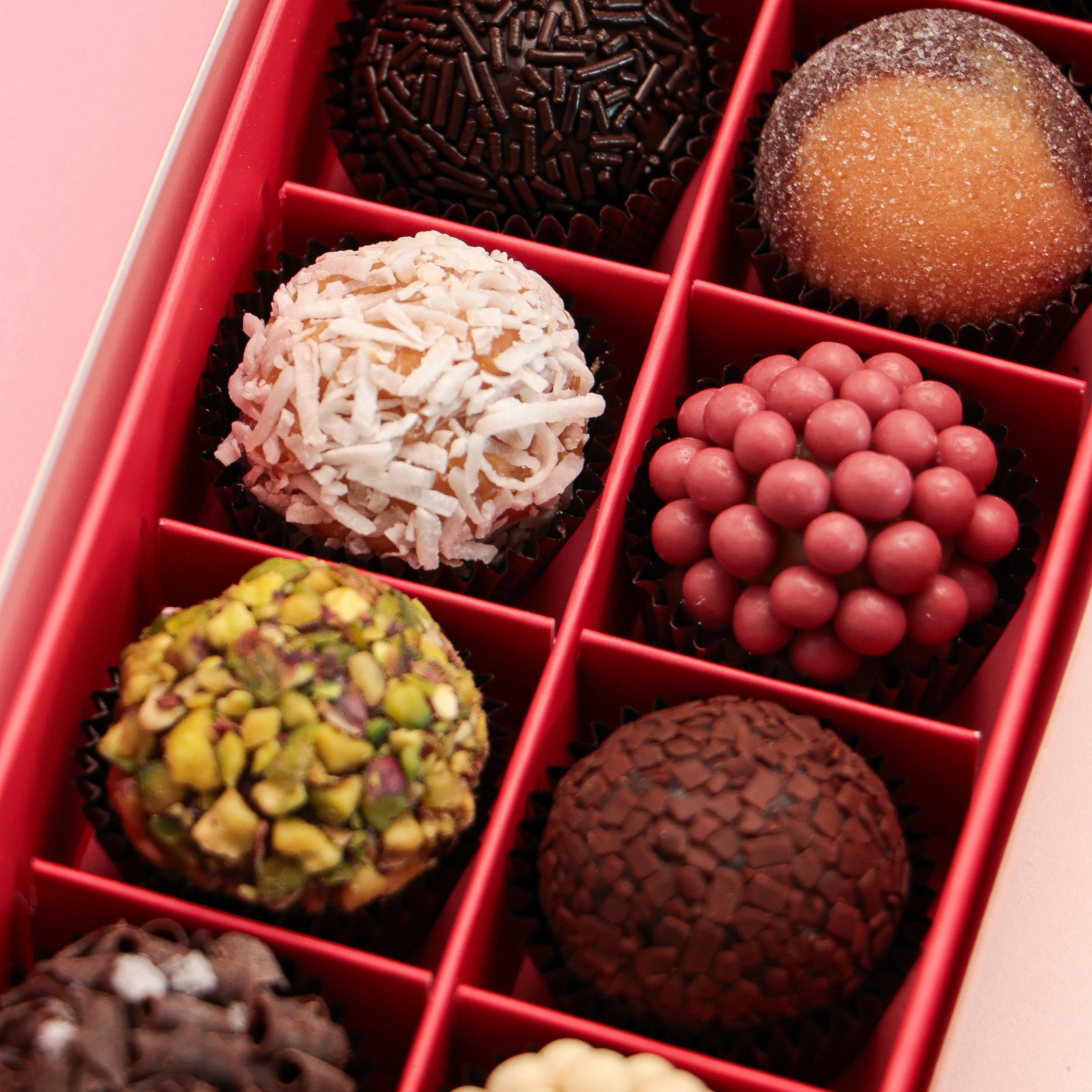 Box of assorted 12 pieces Brigadeiro chocolates with a decorative box on a colorful background