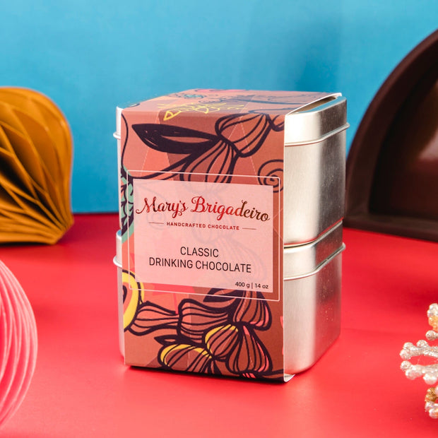 Mary's Brigadero drinking chocolate tin with decorative items on a red and blue background